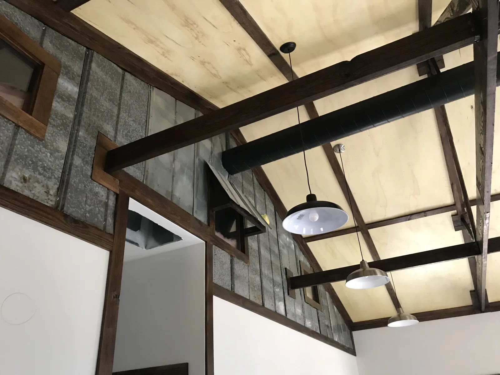Interior view of stained engineered roof trusses manufactured in-house at Hoover Buildings