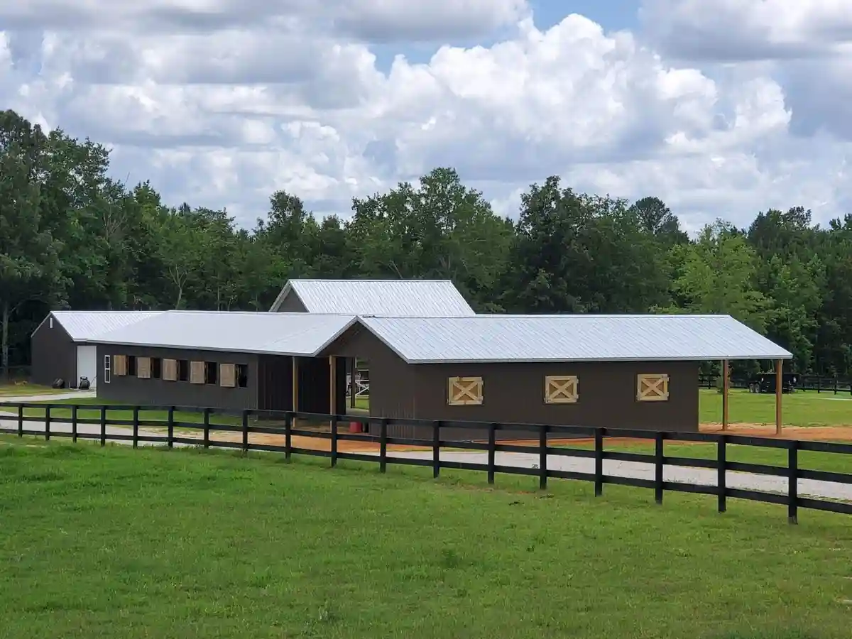 Custom equestrian barn with covered stalls, built by Hoover Building Systems